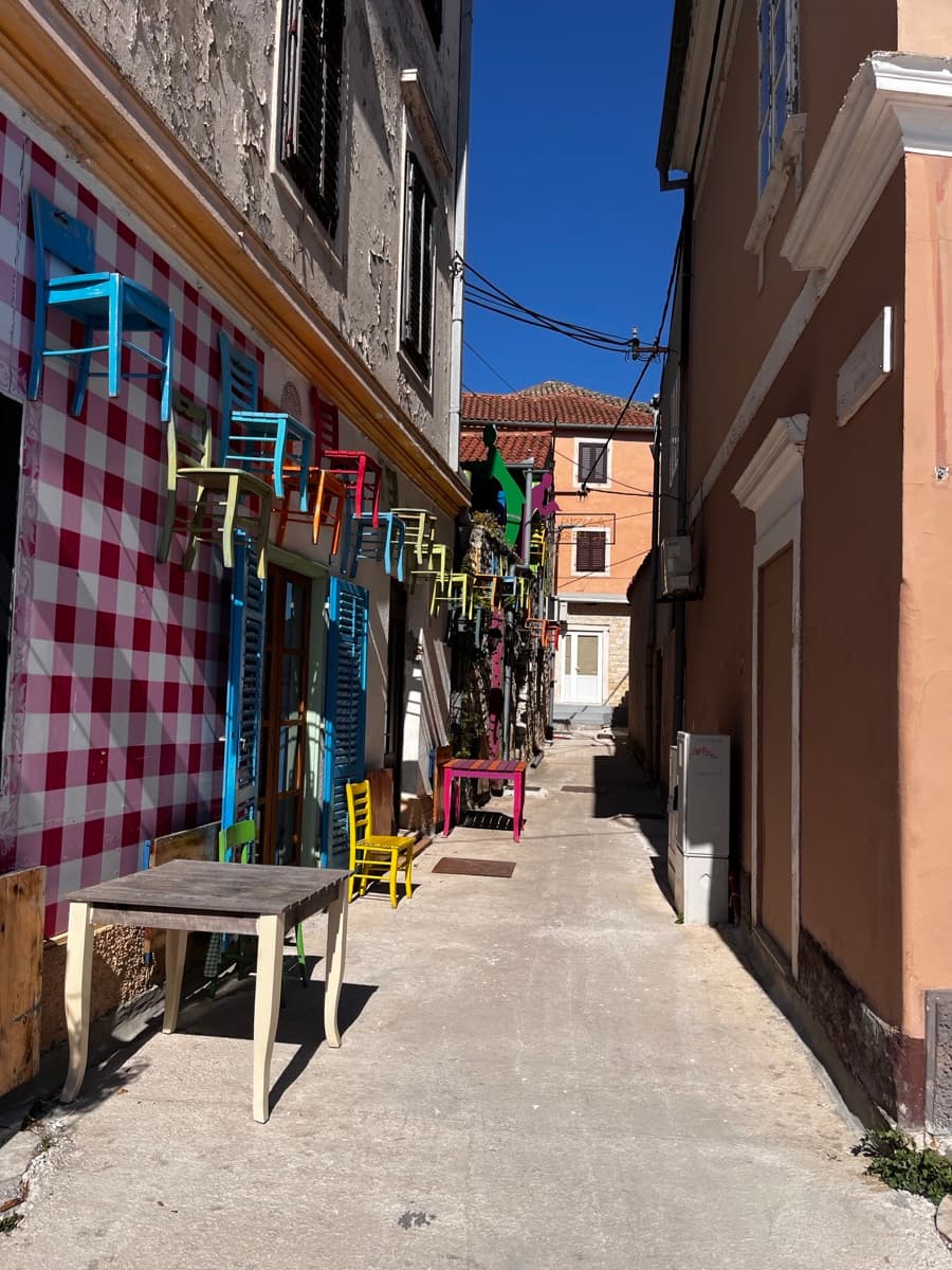 Bistro Europa u Biogradu — šarene stolice, karirani zidovi, bačve kao stolovi